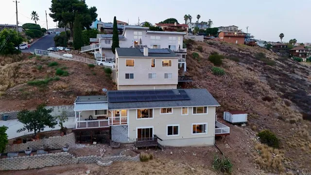 an aerial view of a house with a yard and balcony