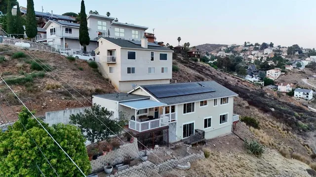 a view of a house with a yard and roof