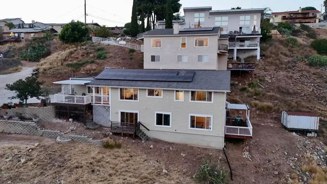 a view of a house with a yard and furniture