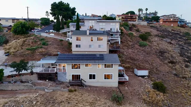a view of a house with a yard and sitting area