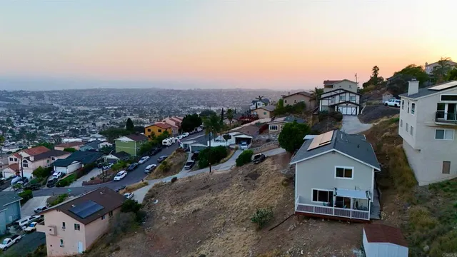 a view of a house with a yard and roof