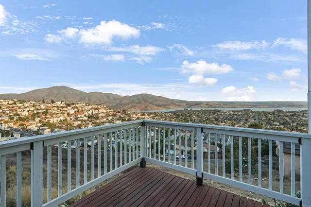 a view of a balcony with wooden floor and city view