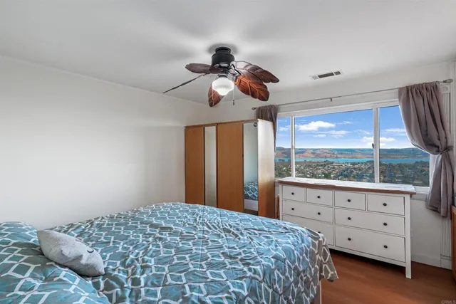 a bedroom with a large bed and a window