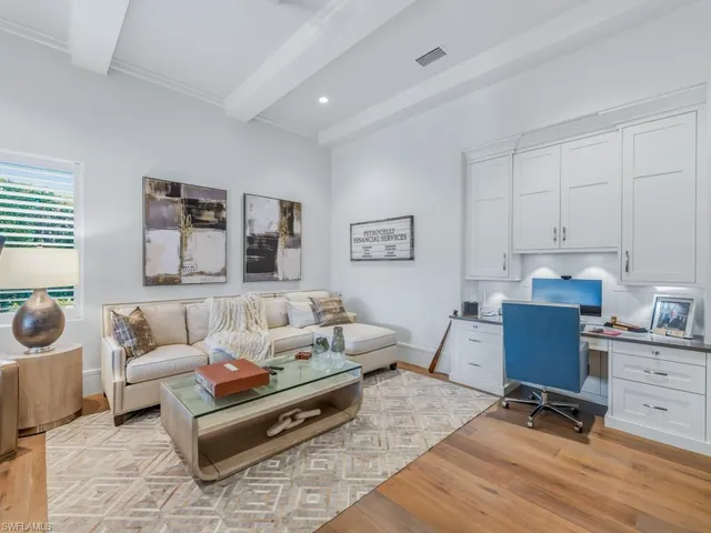 a spacious bedroom with a bed and a potted plant
