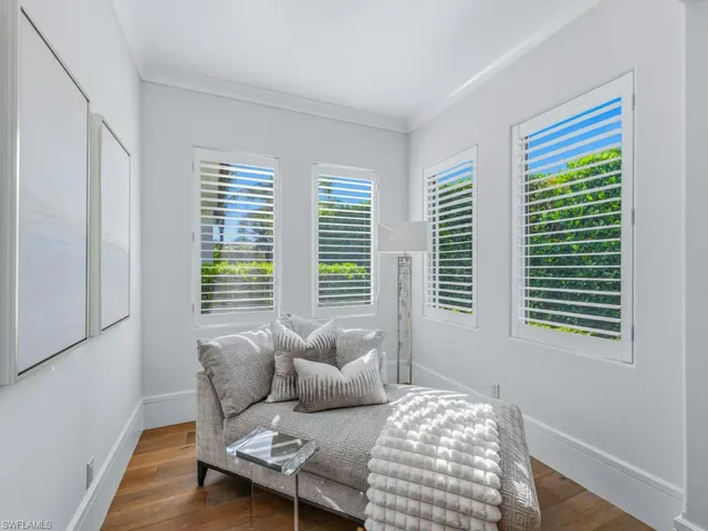 a spacious bathroom with a tub sink and a chandelier