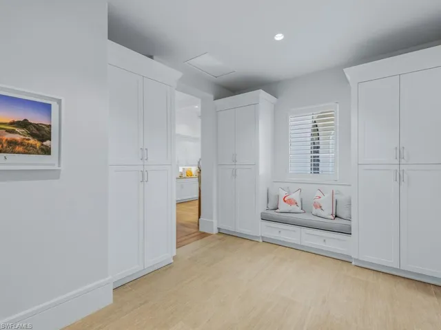 a view of a dining room with furniture large windows and wooden floor