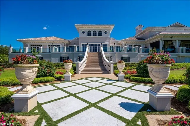 a view of a house with a big yard and potted plants