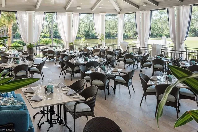a view of a patio with couches table and chairs and potted plants