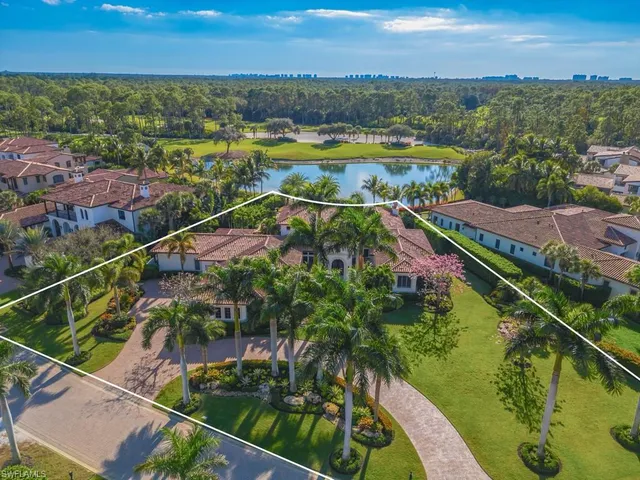 an aerial view of a house with a garden and lake view