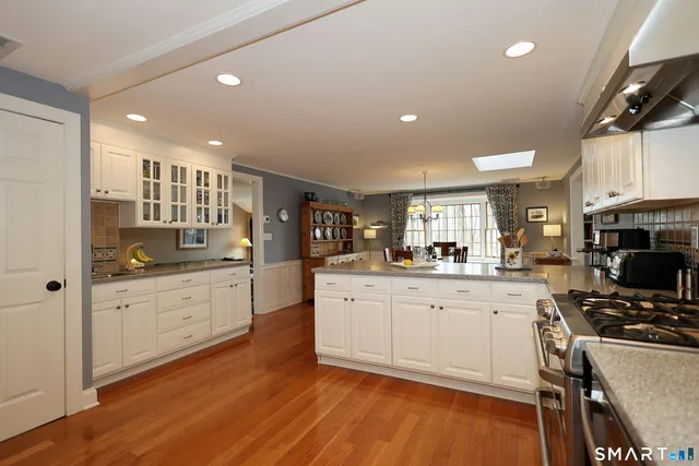 a kitchen with a sink cabinets and wooden floor