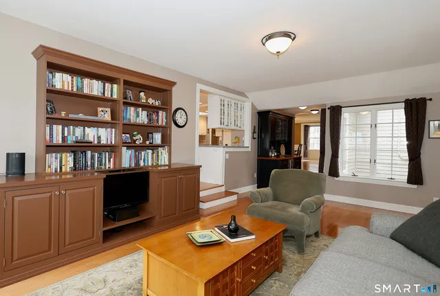 a living room with furniture and a book shelf