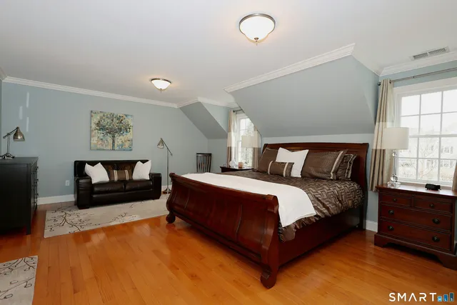 a spacious bedroom with a bed and a couch