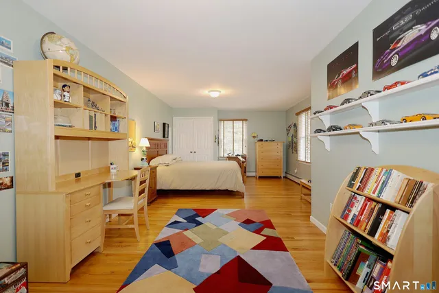 a bedroom with furniture and a book shelf