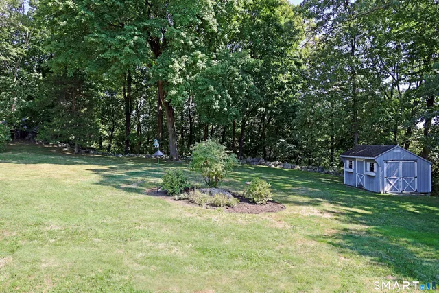 a view of a yard with a house in the background