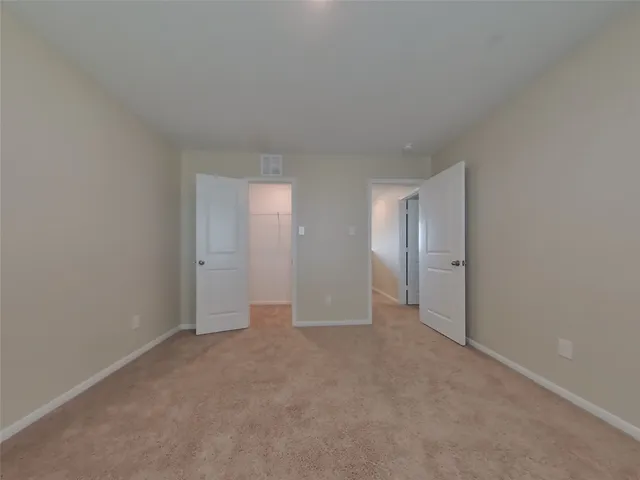 a view of an empty room and closet area