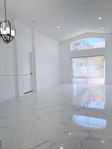 a view of a room with mirror and window