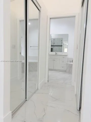 a spacious bathroom with a tub sink and mirror