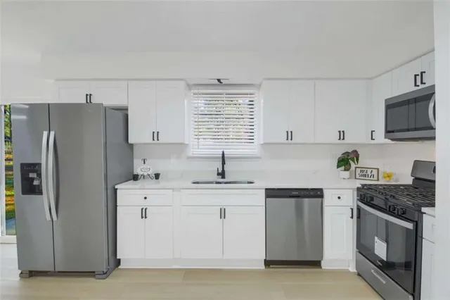 a kitchen with a sink stove and refrigerator