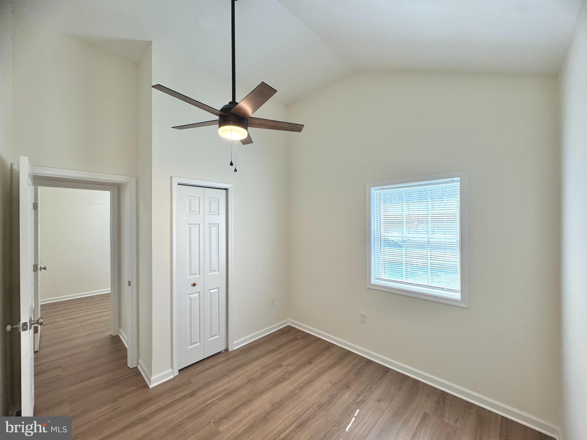 8190 Marshall Corner Road Pomfret, MD 20675 - Photo 12 of 28 wooden floor in an empty room with a window