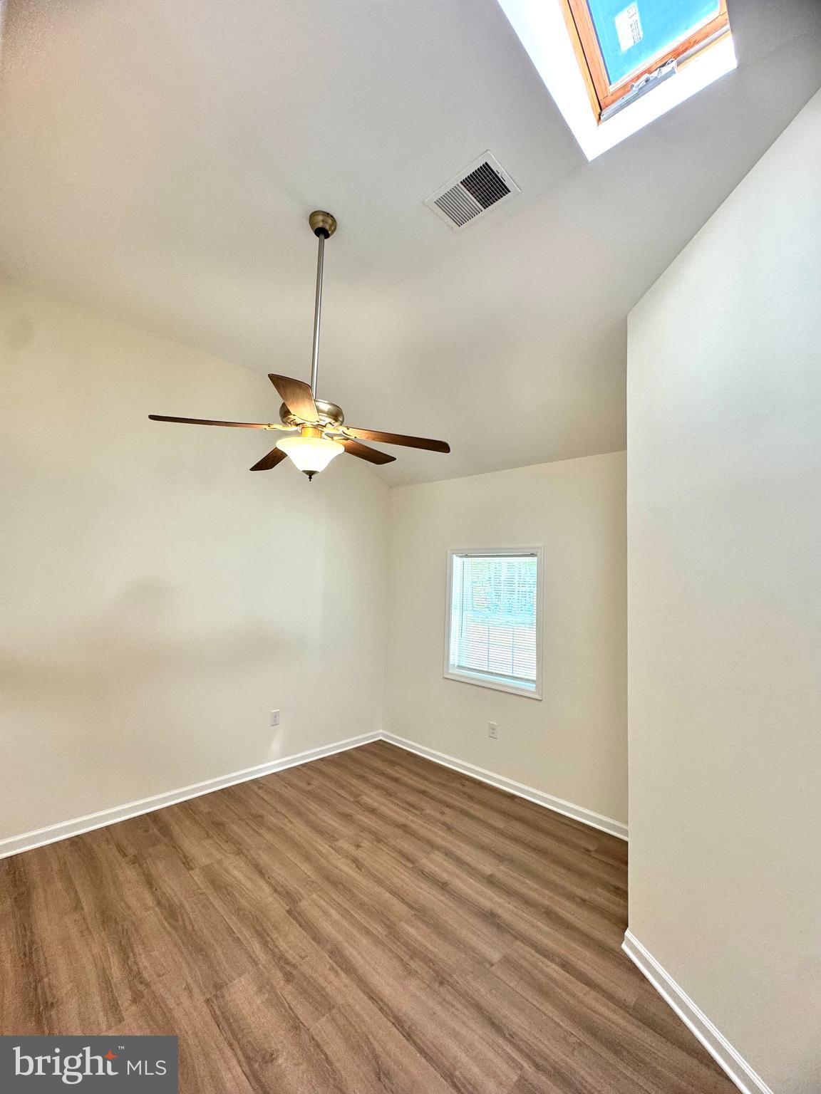 8190 Marshall Corner Road Pomfret, MD 20675 - Photo 15 of 28 a view of a room with wooden floor ceiling fan and windows