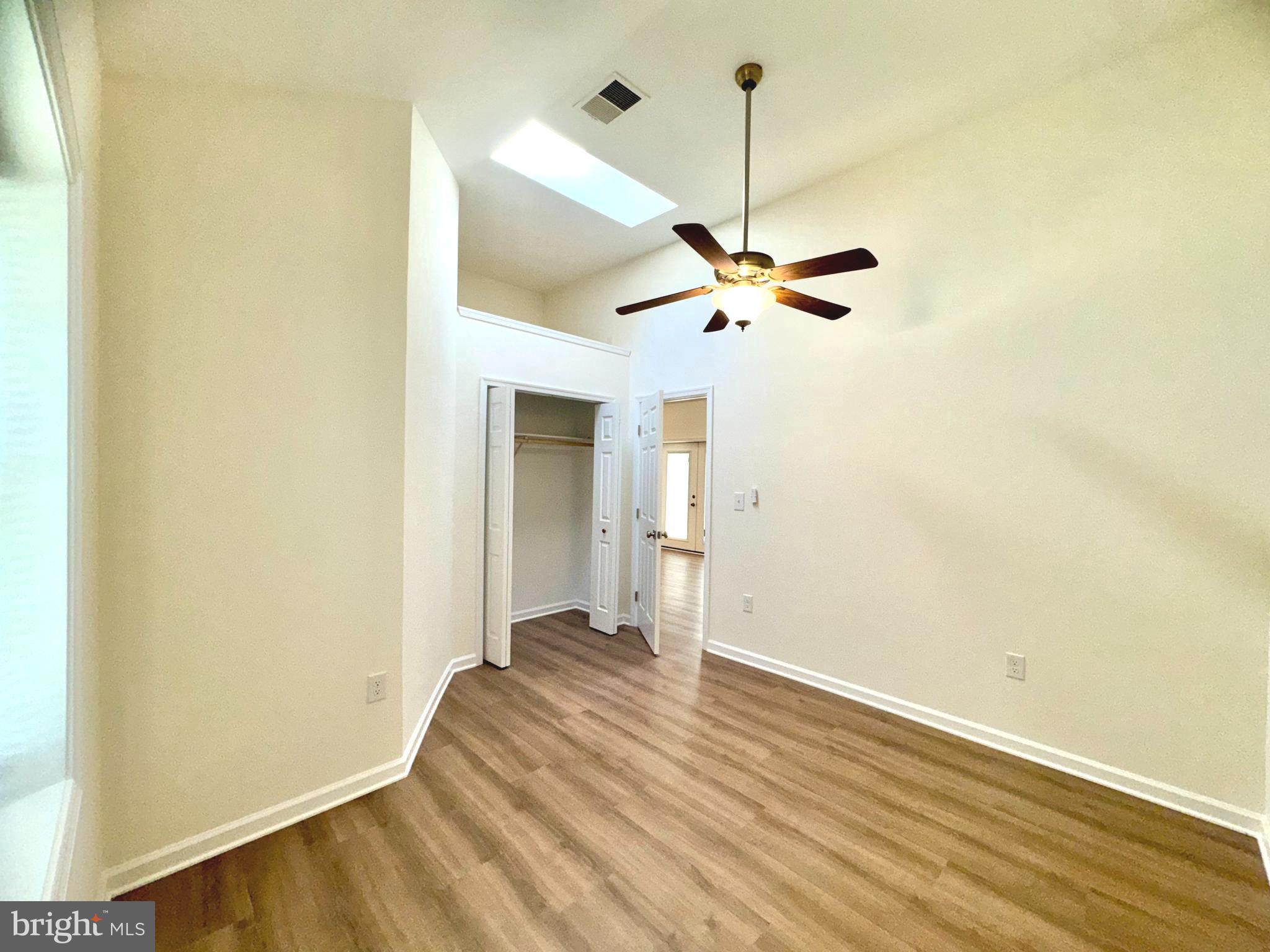 8190 Marshall Corner Road Pomfret, MD 20675 - Photo 17 of 28 a view of a room with a ceiling fan and wooden floor