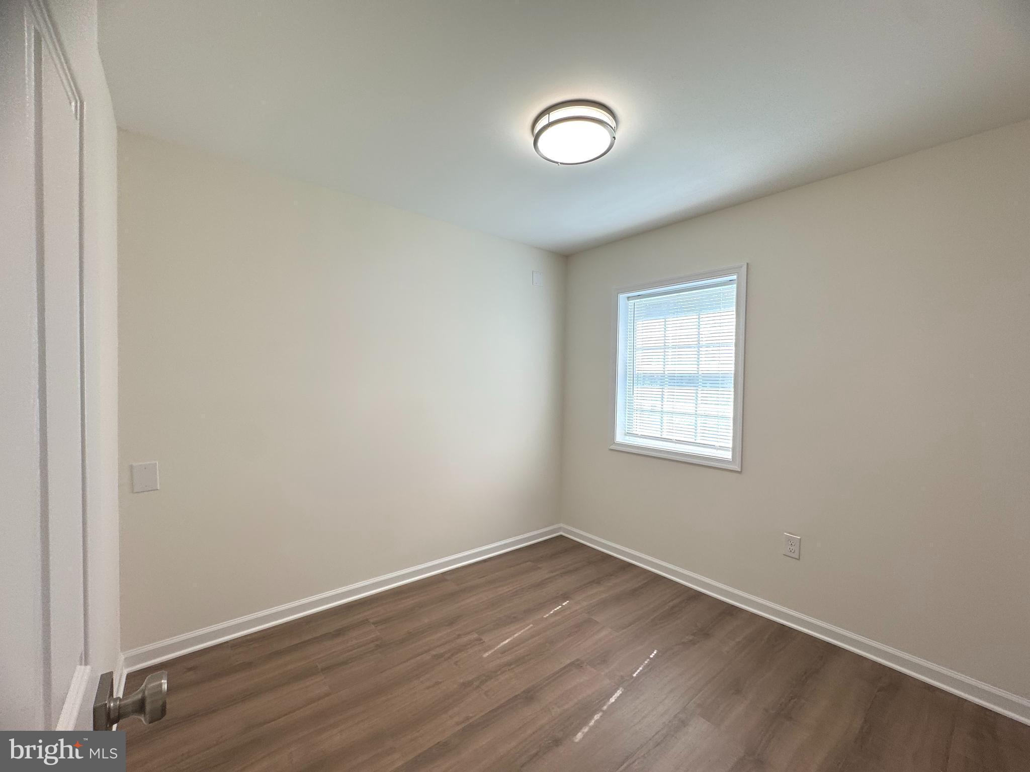 8190 Marshall Corner Road Pomfret, MD 20675 - Photo 18 of 28 an empty room with wooden floor and windows