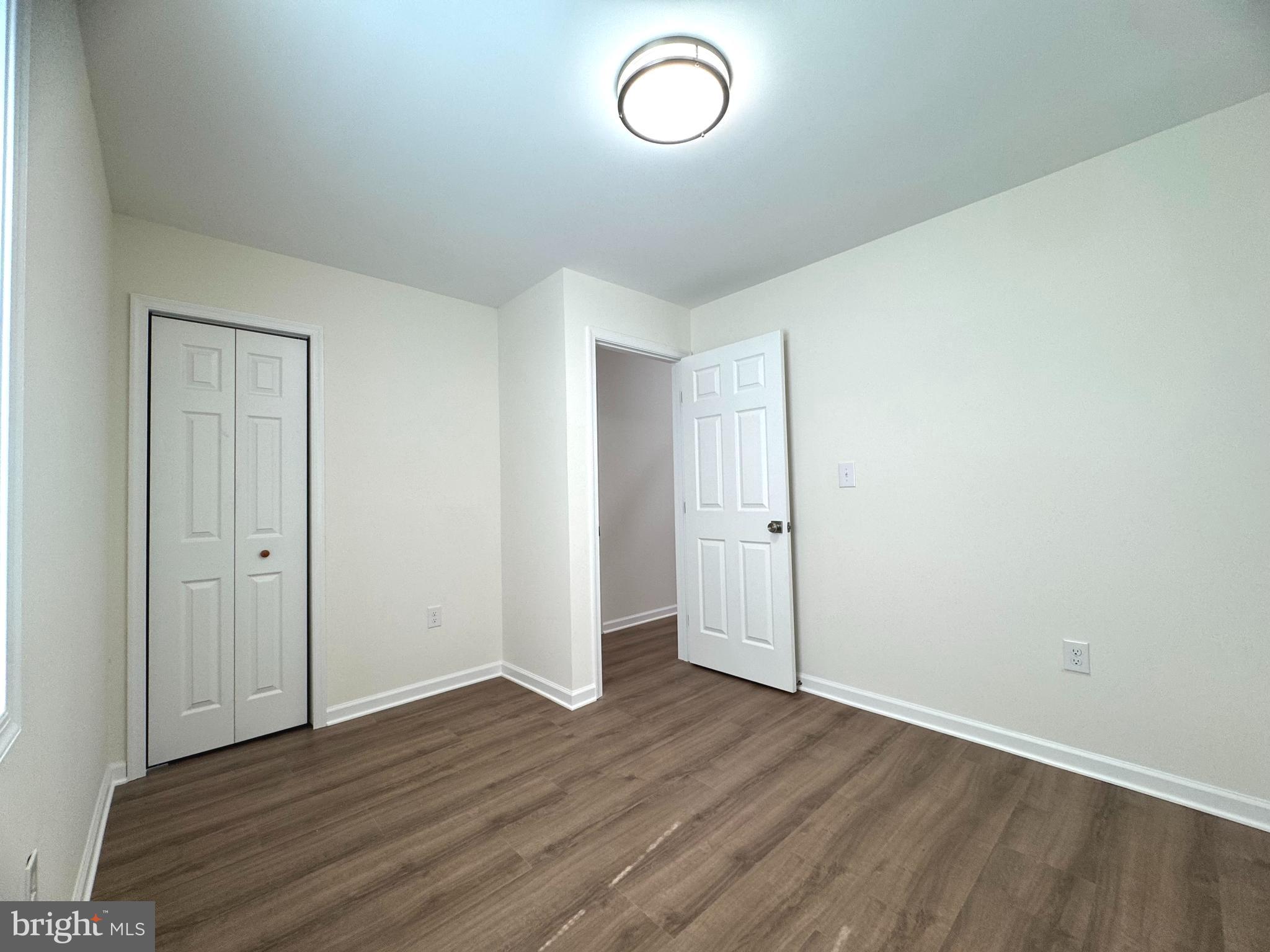 8190 Marshall Corner Road Pomfret, MD 20675 - Photo 19 of 28 an empty room with wooden floor and window