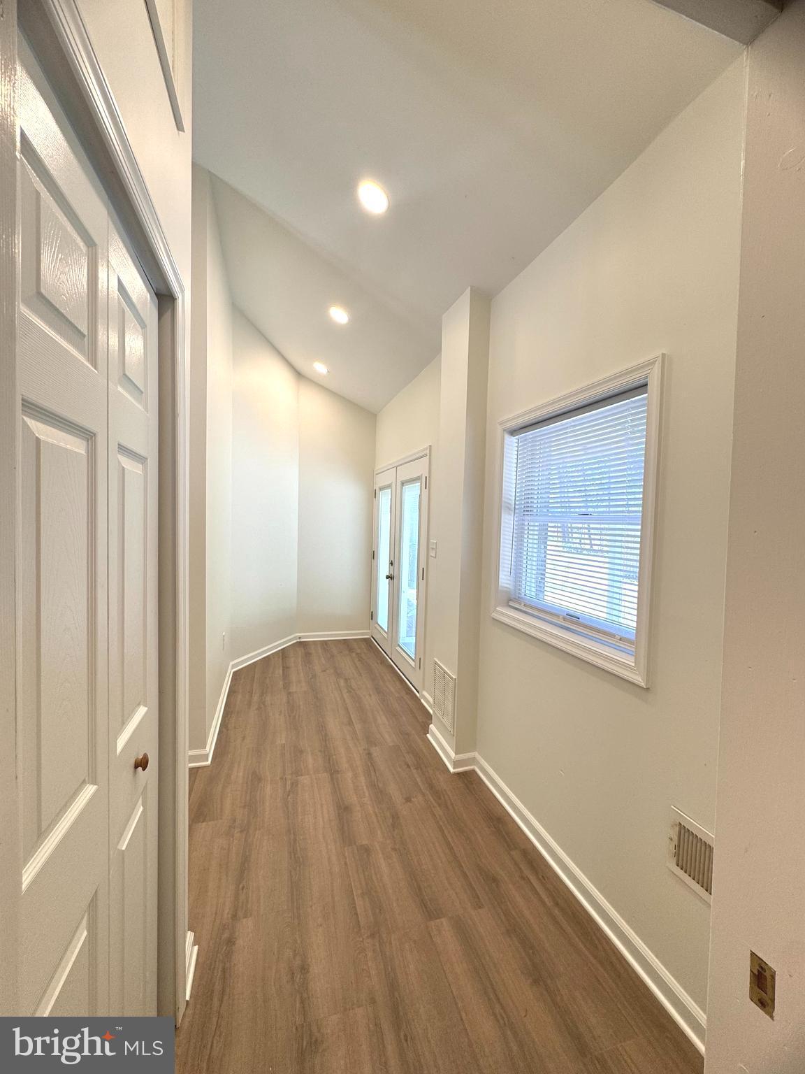 8190 Marshall Corner Road Pomfret, MD 20675 - Photo 21 of 28 a view of hallway with window and wooden floor