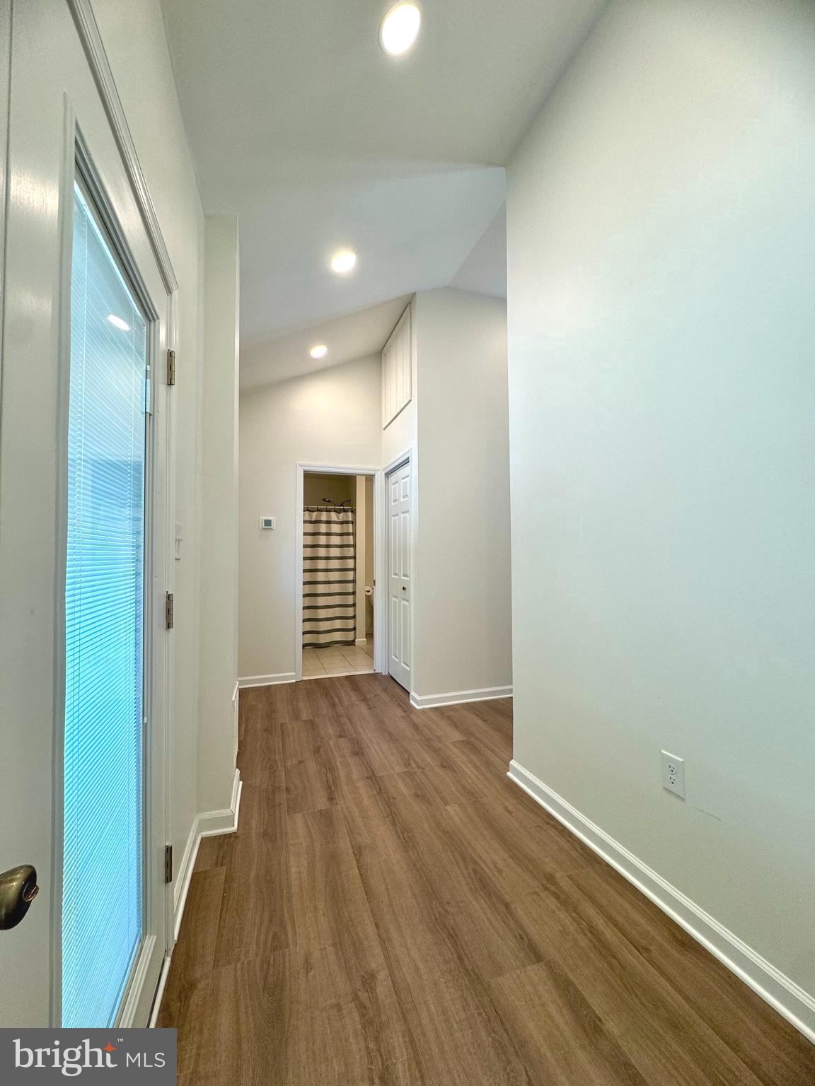 8190 Marshall Corner Road Pomfret, MD 20675 - Photo 6 of 28 an empty room with wooden floor and windows