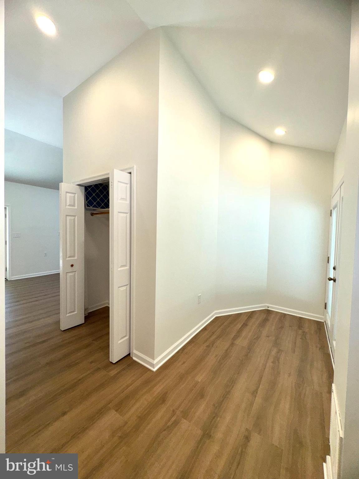 8190 Marshall Corner Road Pomfret, MD 20675 - Photo 7 of 28 an empty room with wooden floor and windows