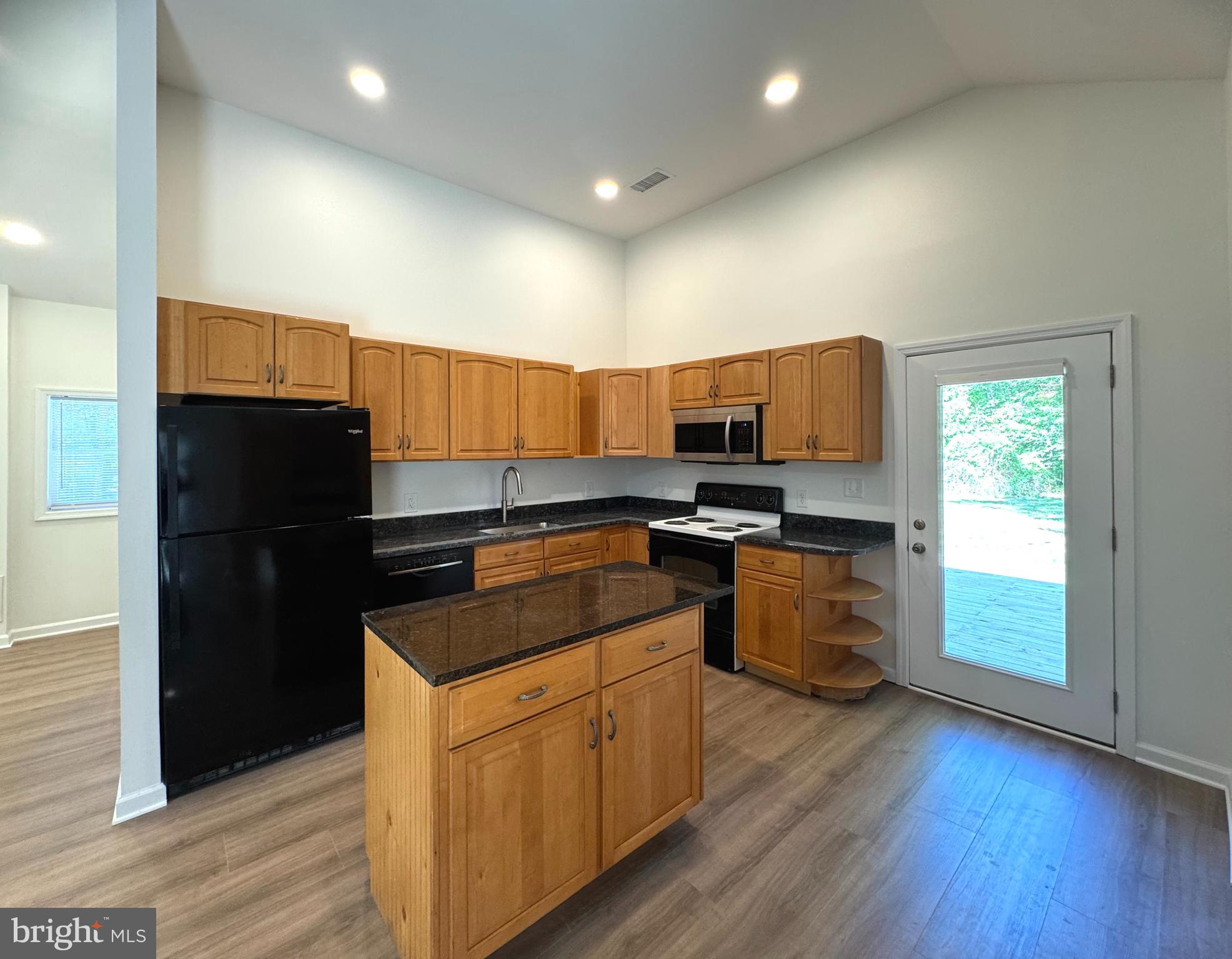 8190 Marshall Corner Road Pomfret, MD 20675 - Photo 9 of 28 a kitchen with granite countertop stainless steel appliances and wooden cabinets