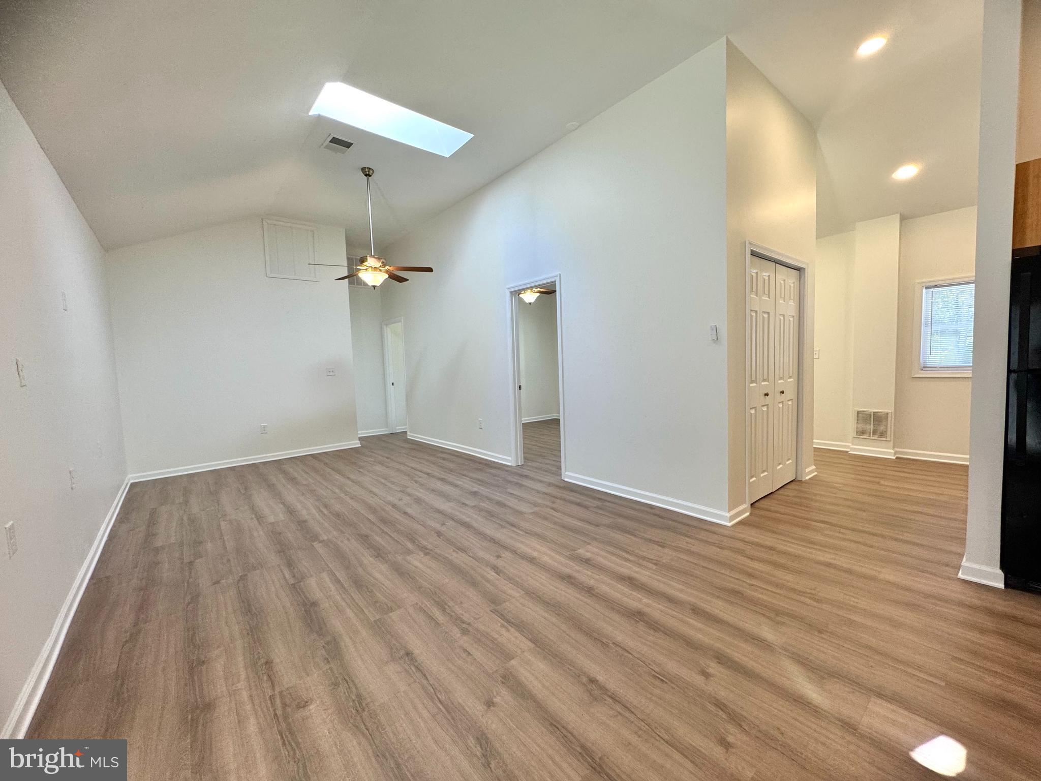 8190 Marshall Corner Road Pomfret, MD 20675 - Photo 10 of 28 a view of a livingroom with wooden floor and a ceiling fan
