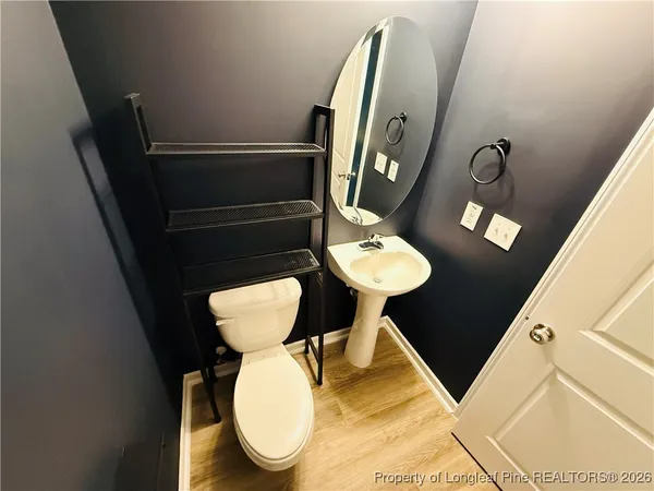 a bathroom with a toilet and a mirror