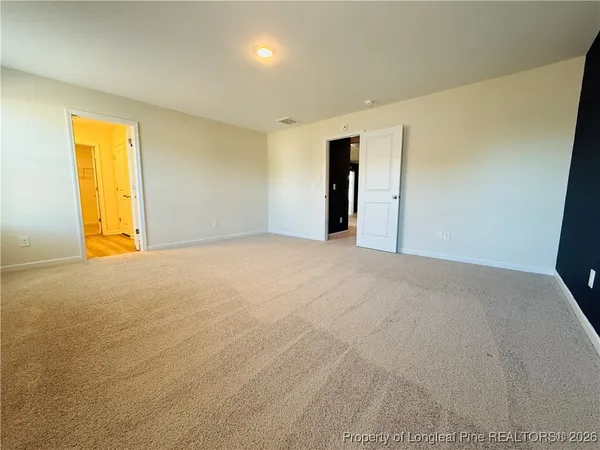a spacious bathroom with a double vanity sink and mirror with shower