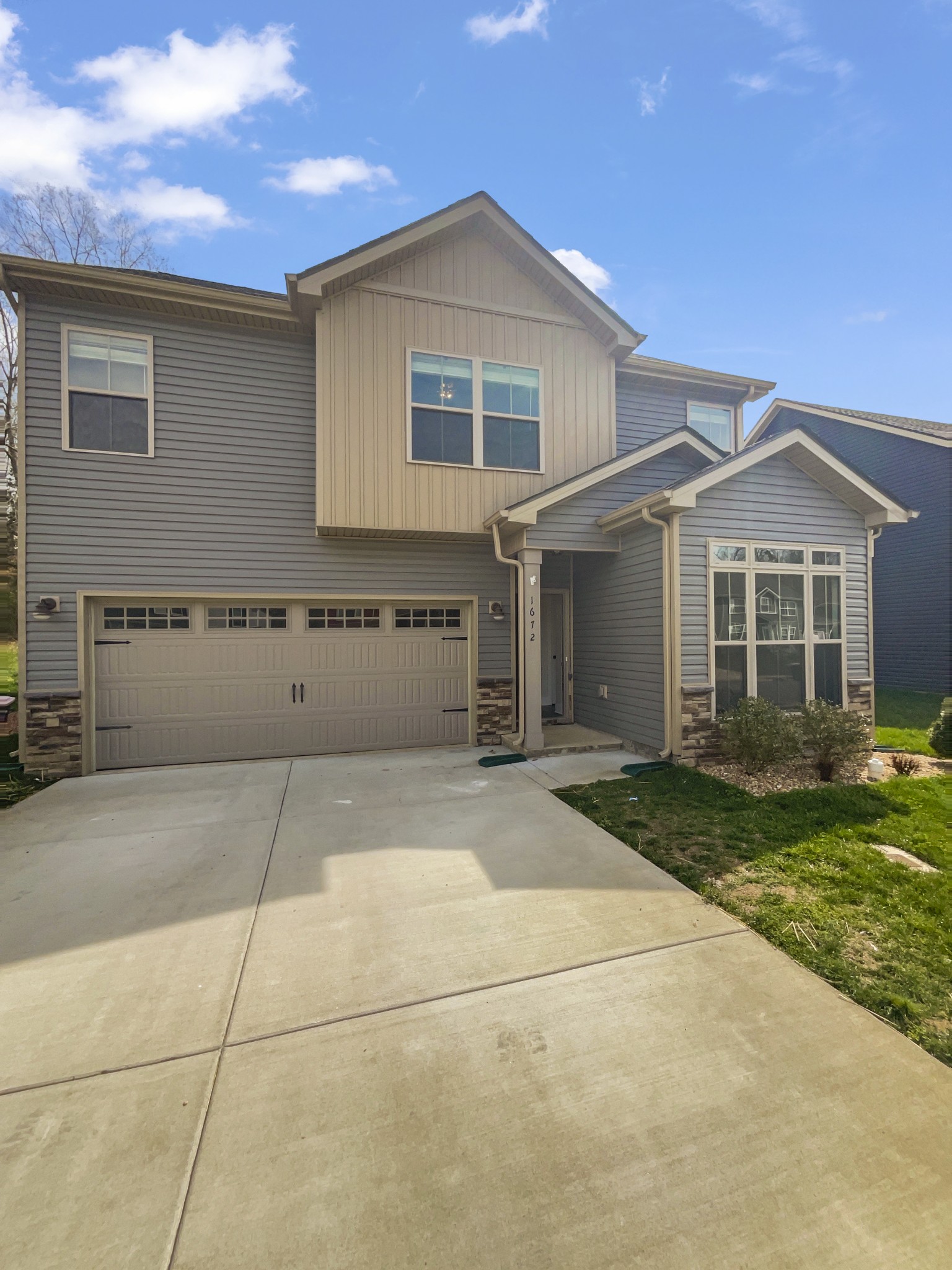 1672 Rains Road Clarksville, TN 37042 - Photo 1 of 23 a front view of a house with a yard and garage