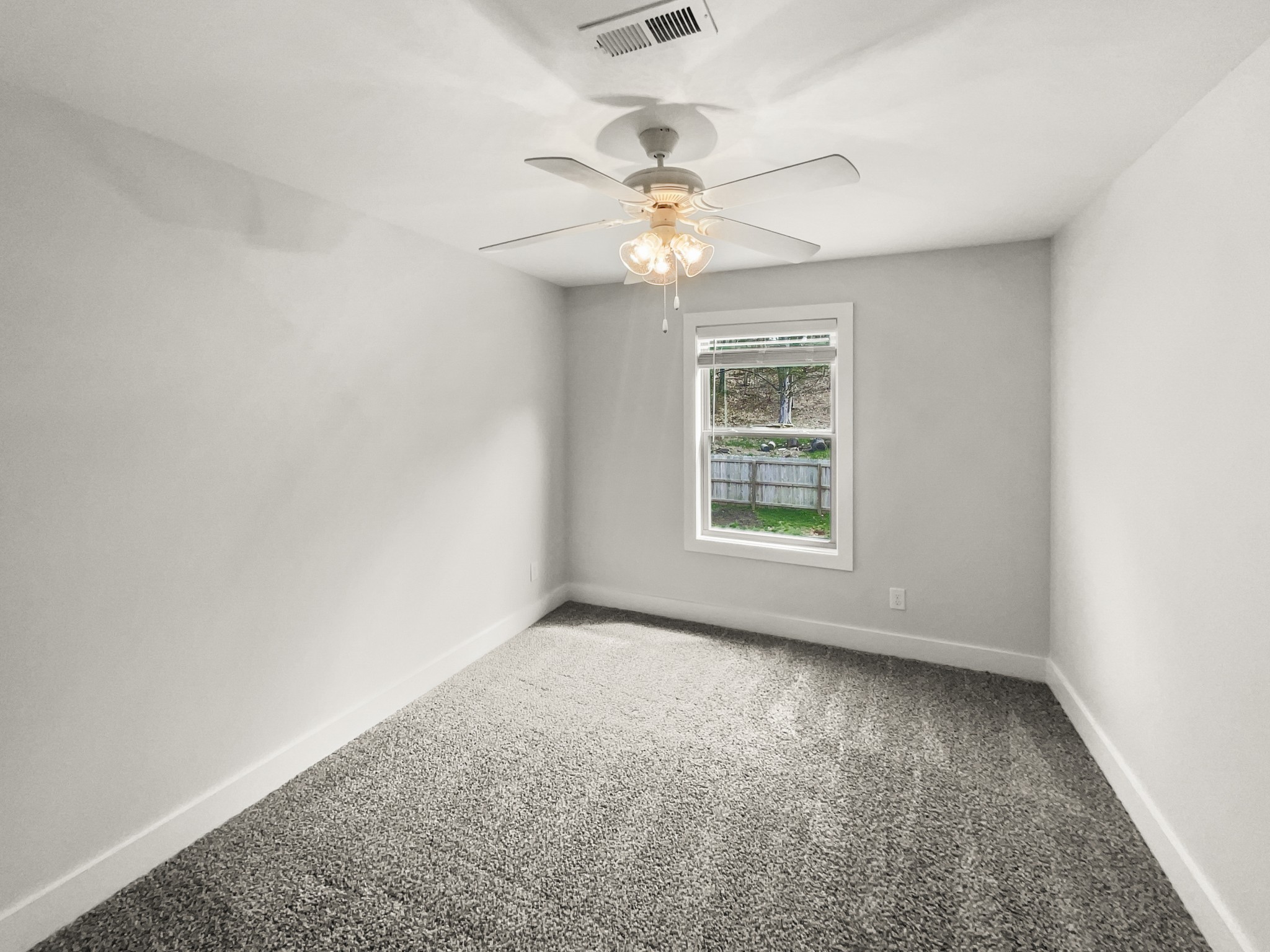 1672 Rains Road Clarksville, TN 37042 - Photo 20 of 23 an empty room with windows and fan