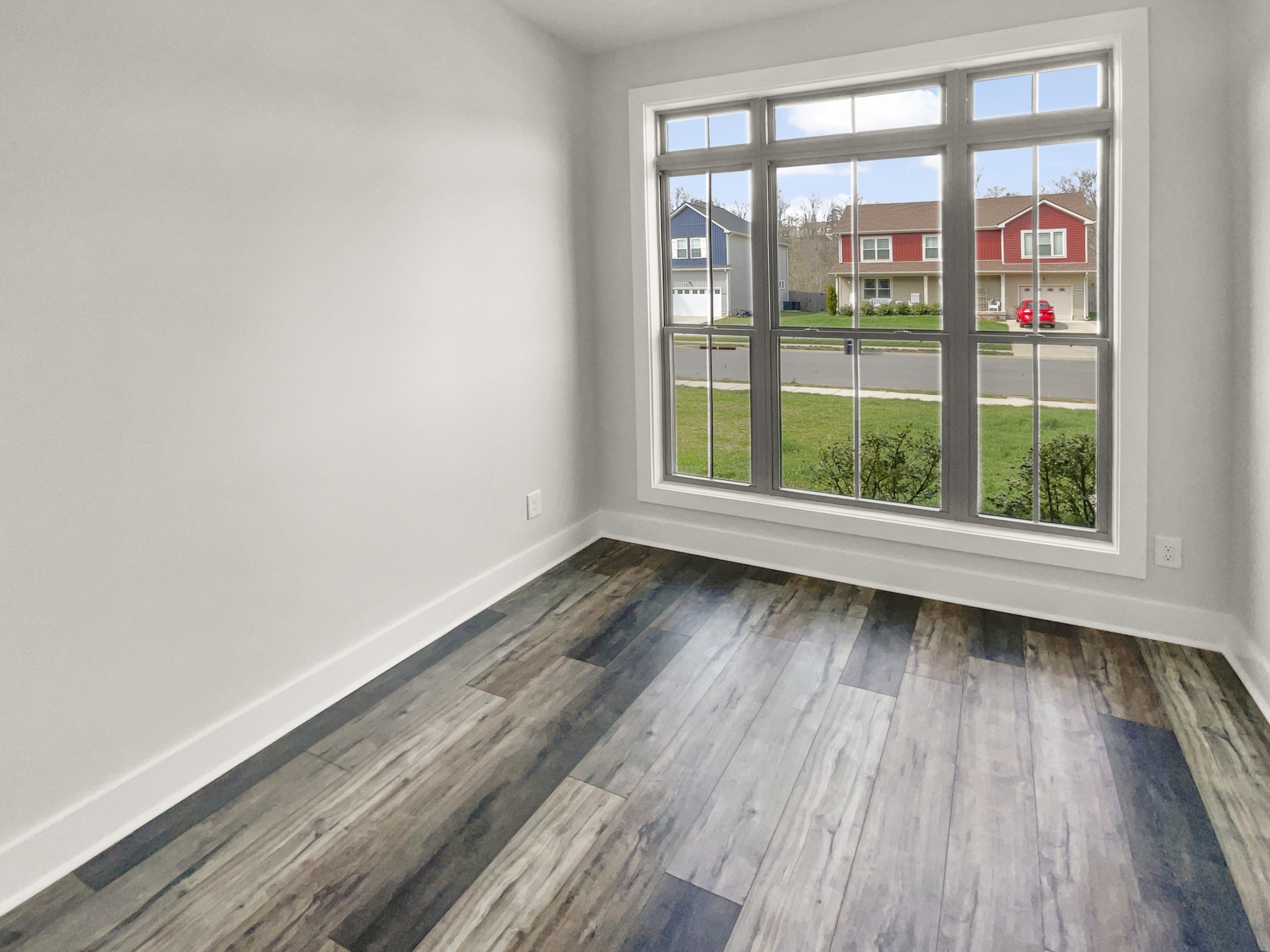 1672 Rains Road Clarksville, TN 37042 - Photo 7 of 23 wooden floor in an empty room with a window