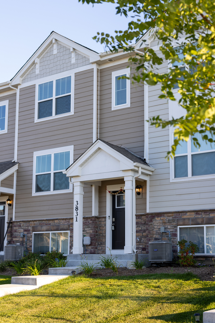 3831 Currant Lane Elgin, IL 60124 - Photo 2 of 20 a front view of a house with a yard and garage