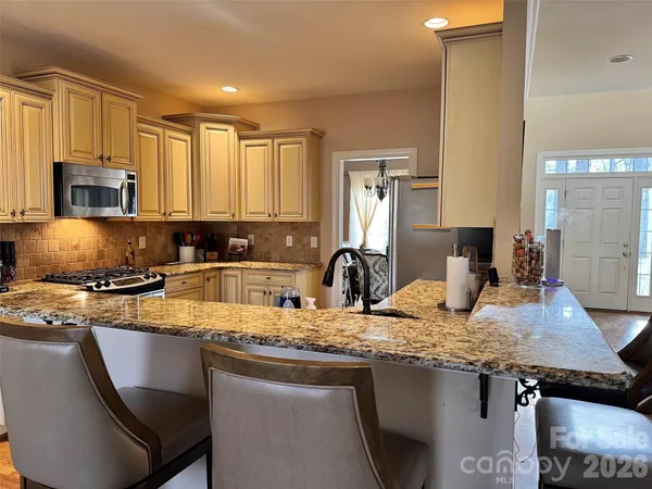 a view of a dining room with furniture and windows