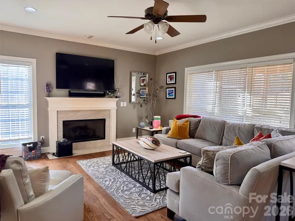 a living room with furniture a fireplace and a flat screen tv