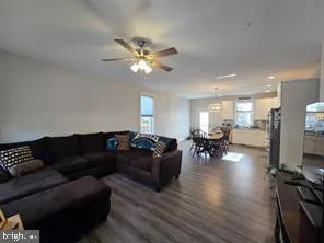 a living room with furniture fireplace and a window