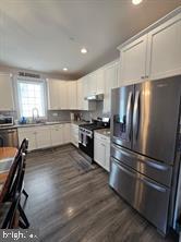 209 3rd Street Crumpton, MD 21628 - Photo 31 of 108 a kitchen with granite countertop stainless steel appliances and wooden cabinets