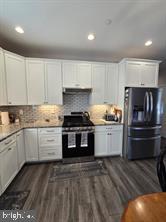 209 3rd Street Crumpton, MD 21628 - Photo 33 of 108 a kitchen with granite countertop white cabinets and stainless steel appliances
