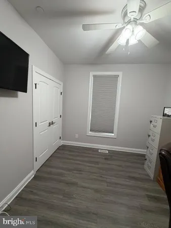 a bedroom with a bed and a ceiling fan