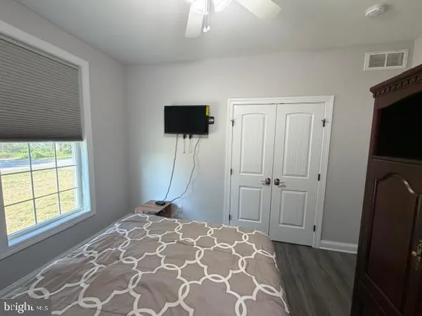 a bed sitting in a bedroom next to a window