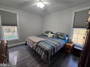 209 3rd Street Crumpton, MD 21628 - Photo 61 of 108 a bedroom with a bed and wooden floor