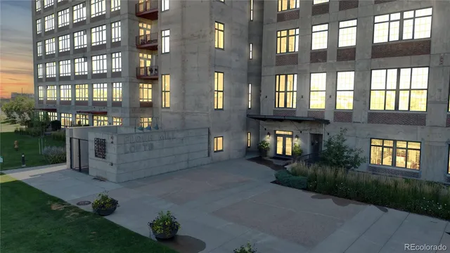 a brick building with a yard in front of it