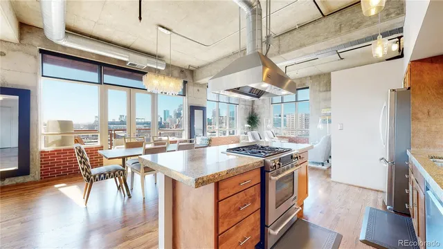 a kitchen with a stove and wooden floor