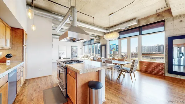 a kitchen with stove and wooden floor
