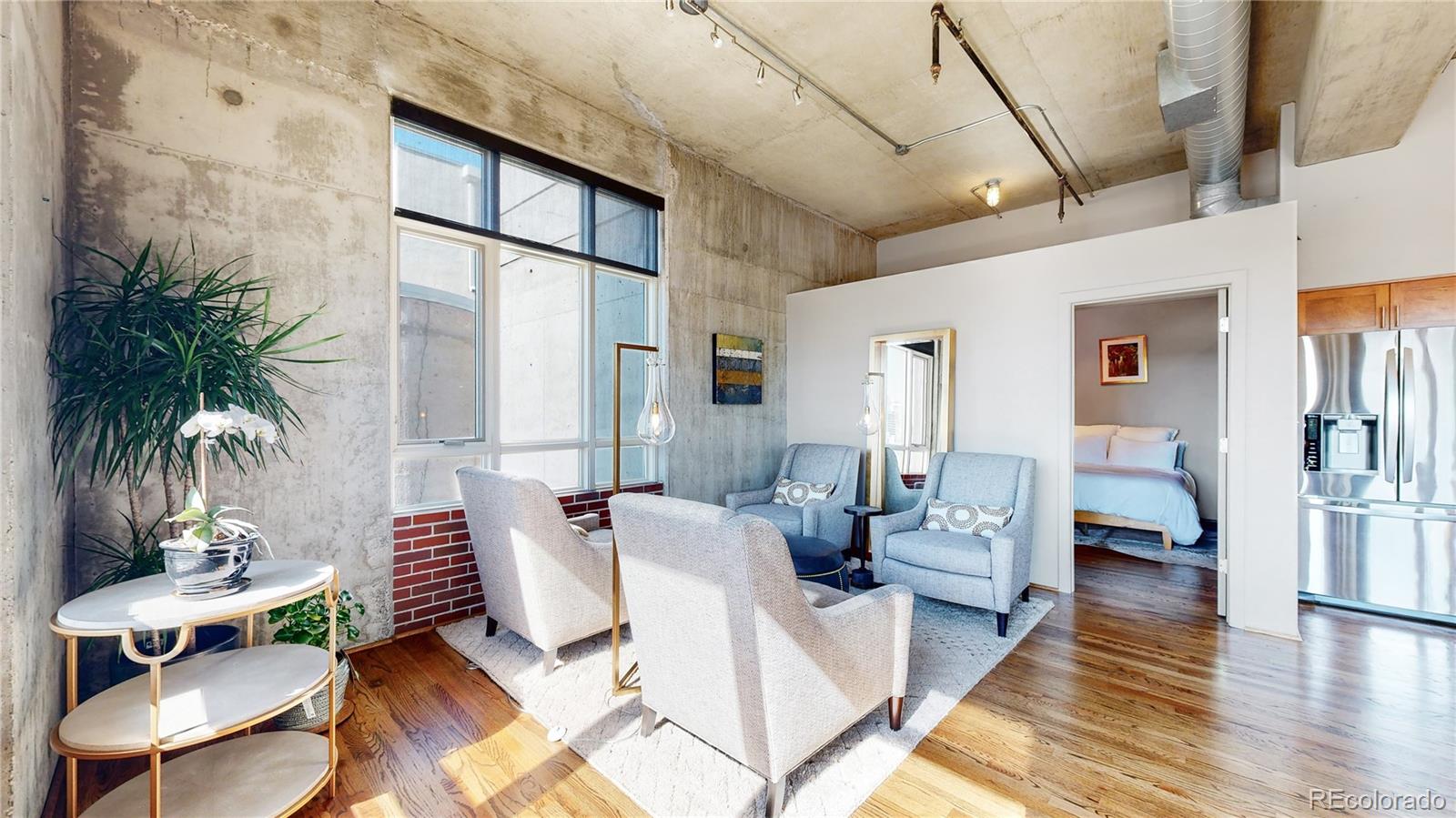 2000 Little Raven Street, Unit 702 Denver, CO 80202 - Photo 17 of 48 a living room with furniture and a large window